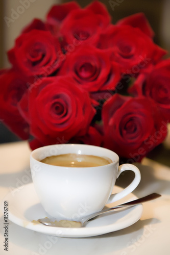 cup of coffee with fresh roses