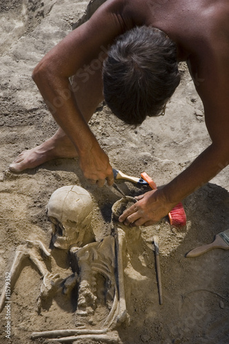 Archaeologist excavating prehistoric grave