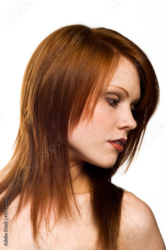 Beautiful young red haired woman isolated on a white background