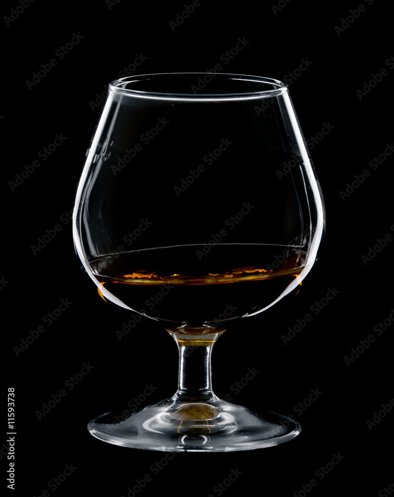 glass of cognac isolated over black background glass of cognac isolated over black background