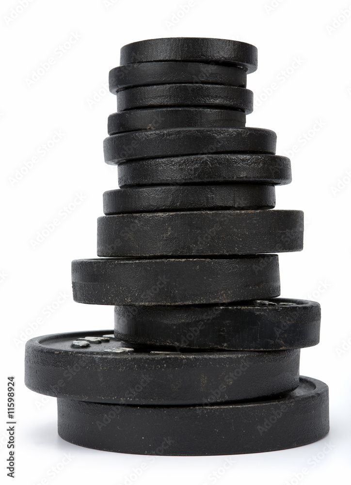 Stack of disk weights isolated on white. Clipping path incl.