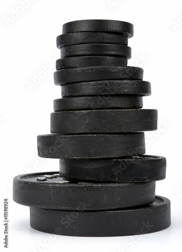 Stack of disk weights isolated on white. Clipping path incl.