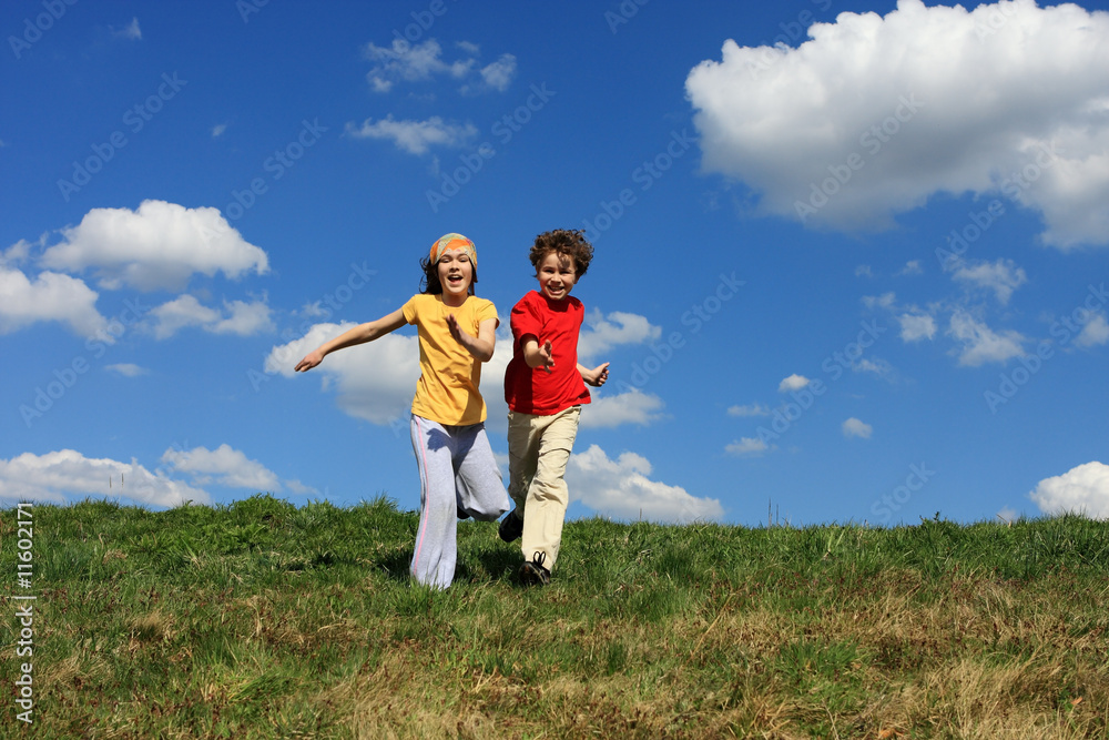 Kids jumping, running against blue sky Kids jumping, running against blue sky