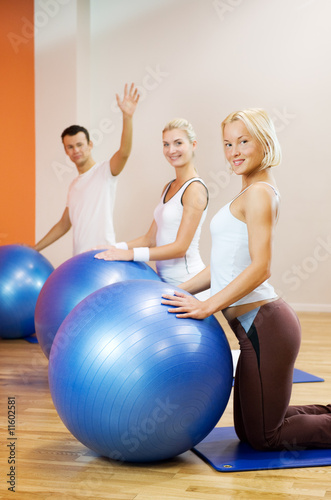 Group of people doing fitness exercise with a ball