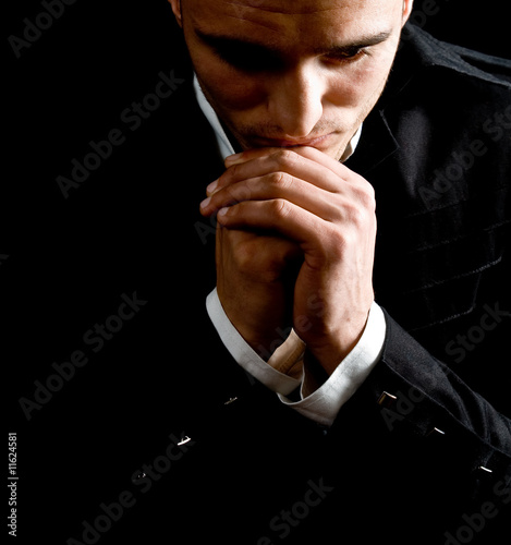 Faith concept of thoughtful man saying prayer