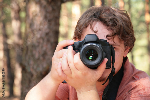Photographer photographs in forest