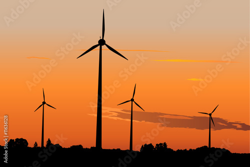 Wind turbines against dramatic sunset