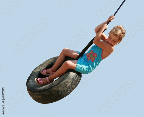 Girl playing on tire swing