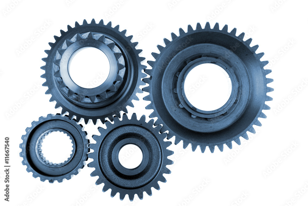Steel gears meshing together over white Steel gears meshing together over white