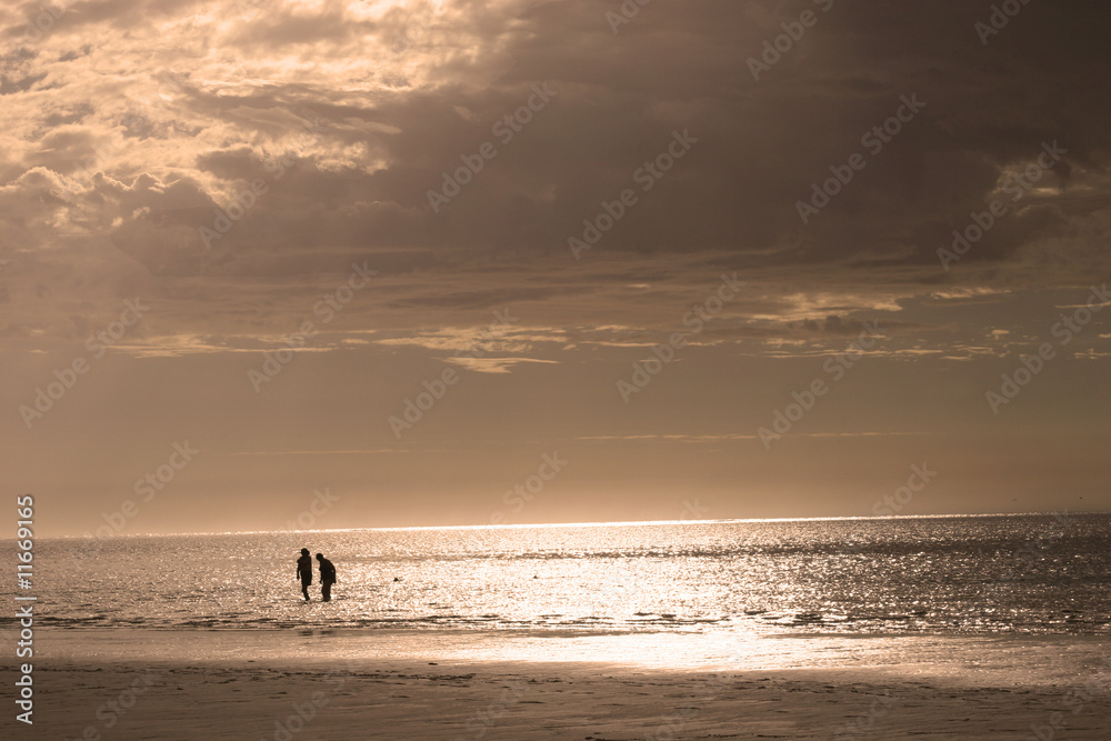 Retired couple on beach at Sunset