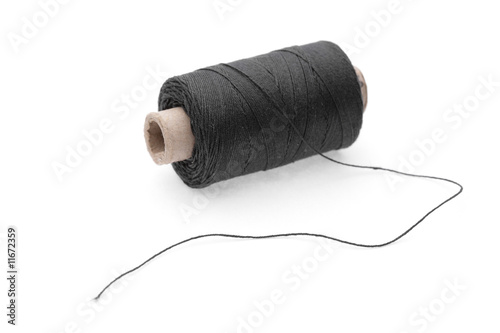 The coil of black threads on white background