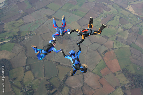 Four skydivers in a star formation