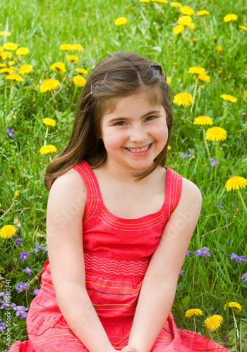 Girl Smiling in Front of Flowers