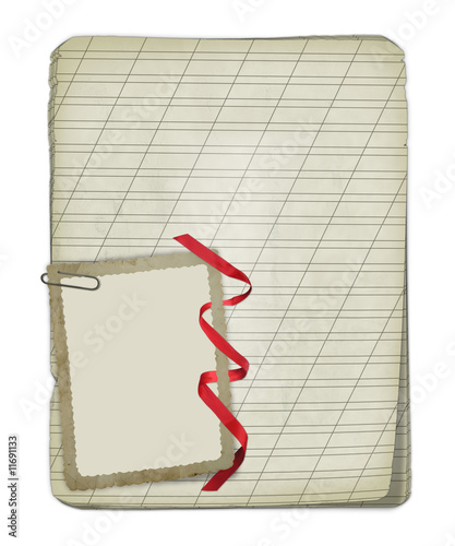 Old notebook with a photoframe on the isolated white background photo