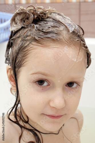 Foto child with a head covered with a soap