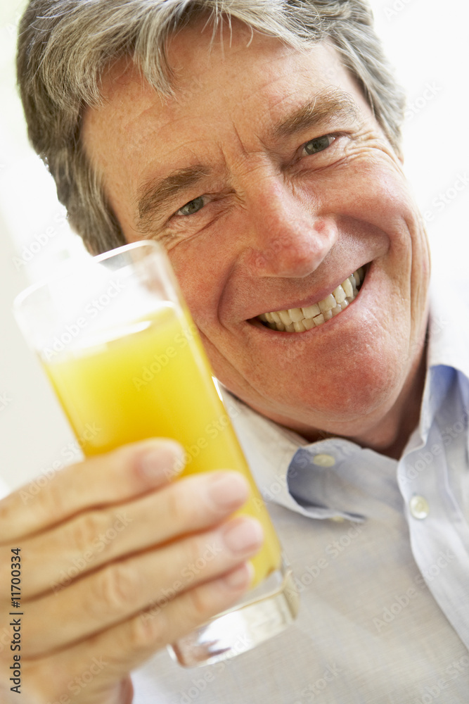 Senior Man Smiling At Camera And Drinking Orange Juice Senior Man Smiling At Camera And Drinking Orange Juice