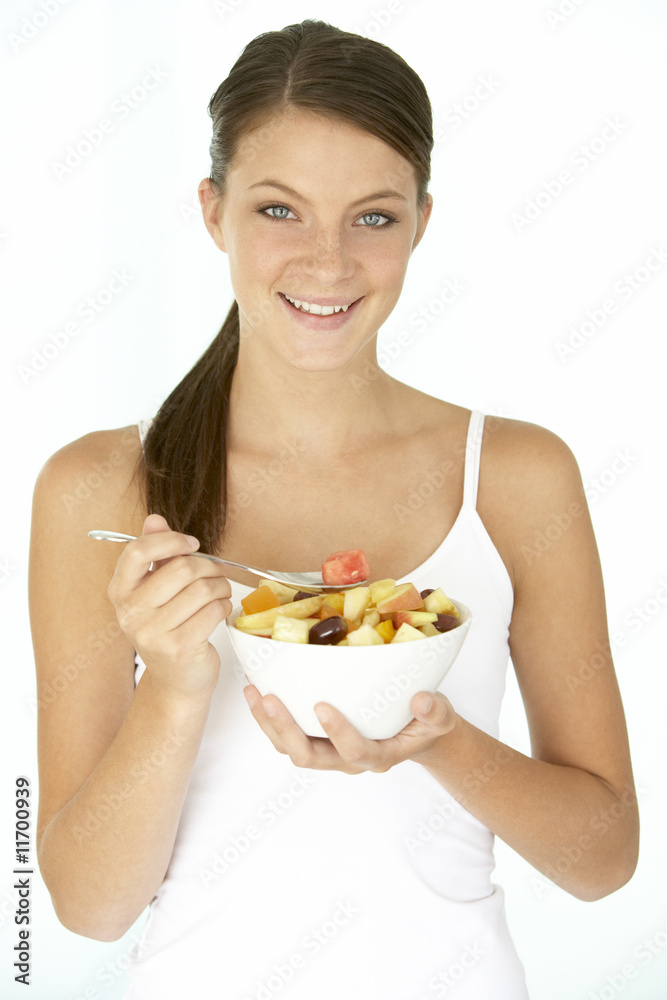 Young Woman Eating Fresh Fruit Salad Young Woman Eating Fresh Fruit Salad