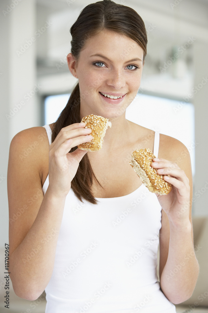 Young Woman Eating Brown Bread Roll Young Woman Eating Brown Bread Roll