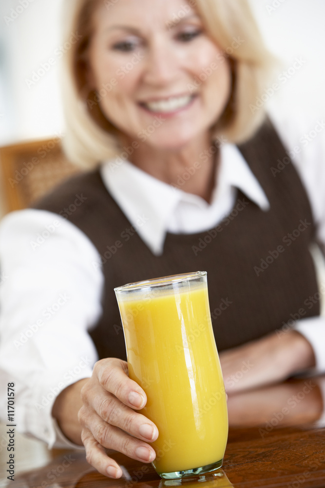 Senior Woman Drinking A Glass Of Fresh Orange Juice Senior Woman Drinking A Glass Of Fresh Orange Juice