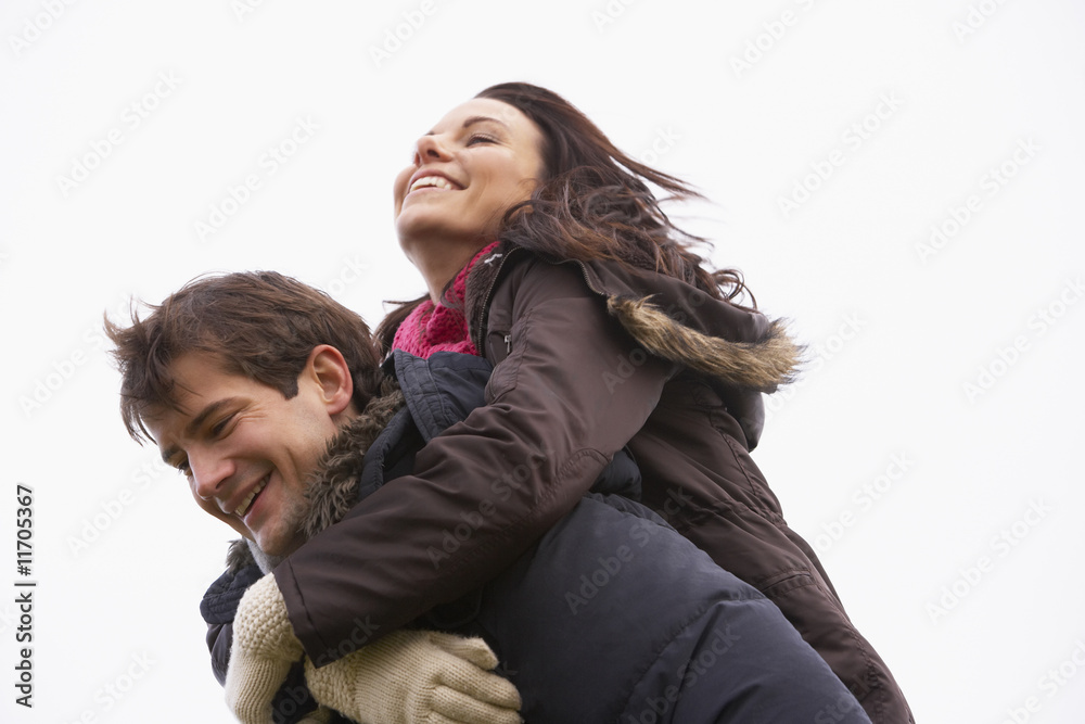 Man Giving His Wife Piggy Back Ride Man Giving His Wife Piggy Back Ride