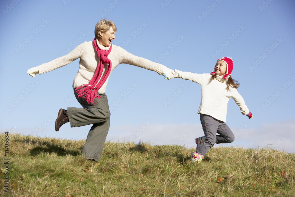 Granddaughter Running And Pulling Grandmother By The Hand Granddaughter Running And Pulling Grandmother By The Hand