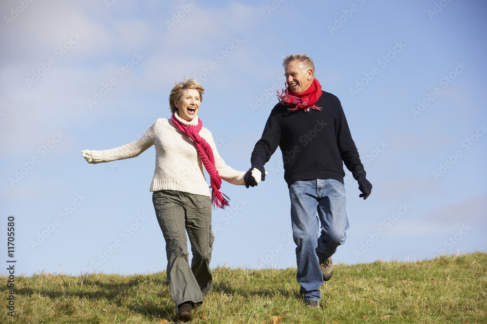Senior Couple Running In The Park