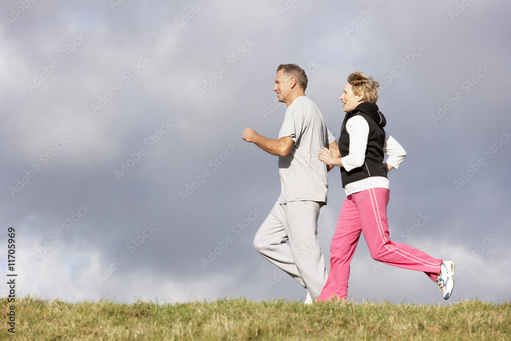 Senior Couple Jogging In The Park Senior Couple Jogging In The Park