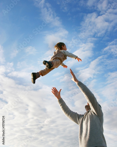 flying boy on sky background