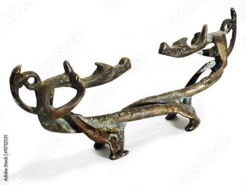 old figurine made of bronze in the form of two dragons