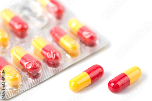 red and yellow capsule pills in blister isolated