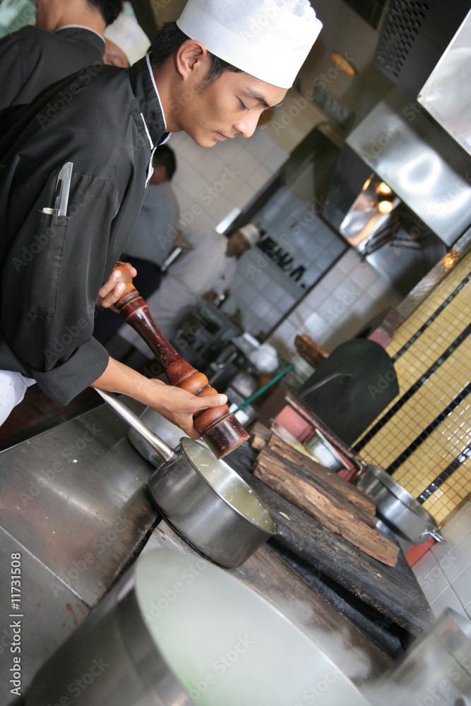 Chef cooking at kitchen restaurant Chef cooking at kitchen restaurant