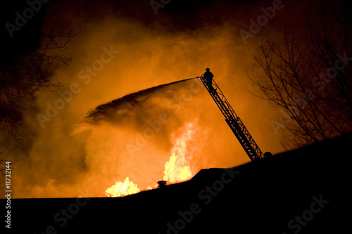 Fireman Spraying Water into a Fire