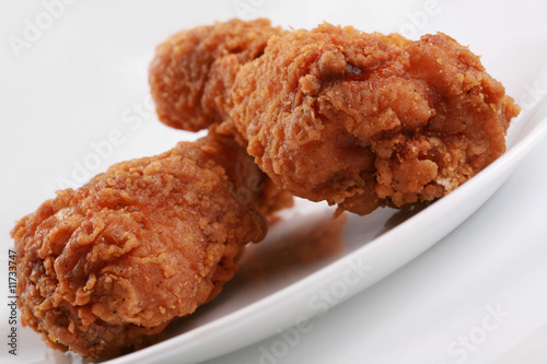 Two crispy fried chicken drumsticks photo