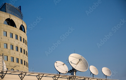 Satellite antennas on a roof of modern office building