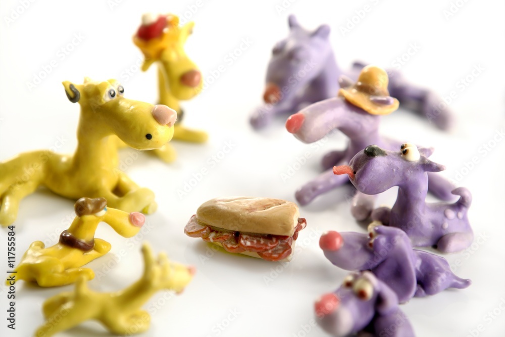 Handmade hungry plasticine dogs, meat to eat