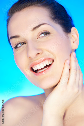 Portrait of 20-25 years old beautiful woman on blue background