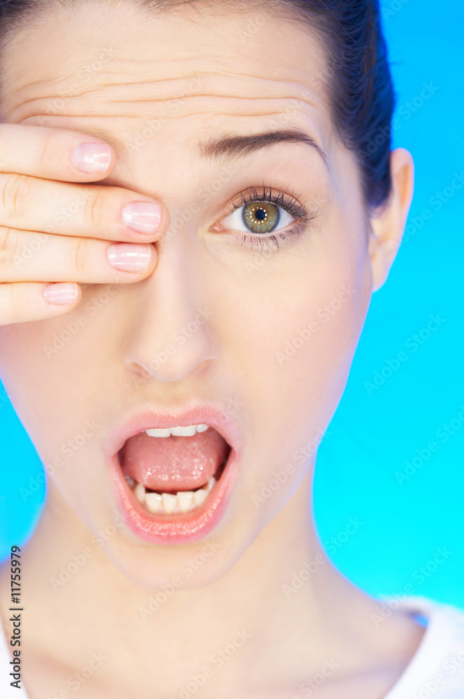 Obraz premium Portrait of beautiful woman with eye covered by hand