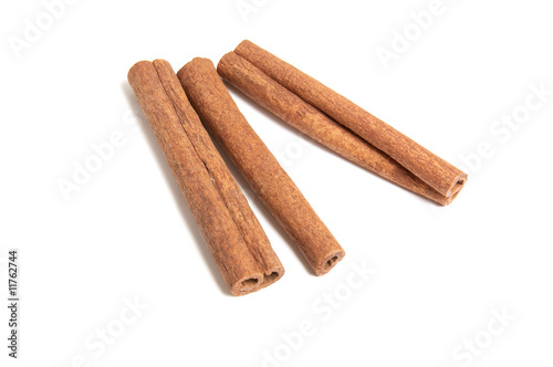 Three cinnamon sticks on white background.