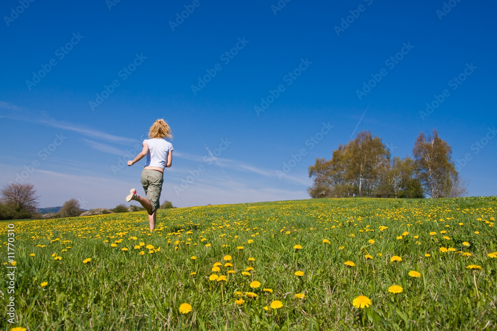 young female having fun on flowery meadow young female having fun on flowery meadow