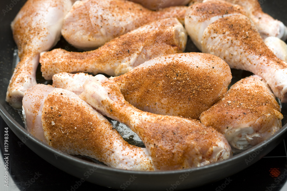 Frying chicken legs with pepper.