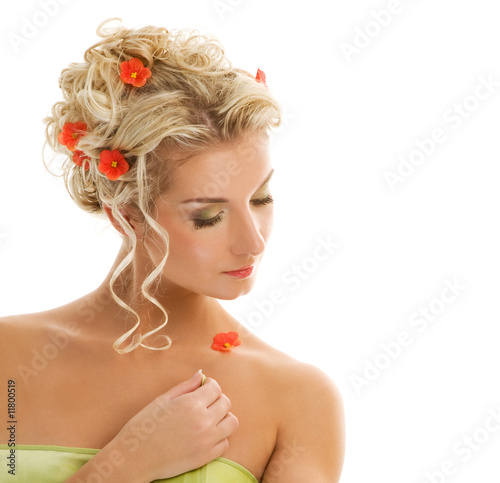 Beautiful young woman with fresh spring flowers in her hair