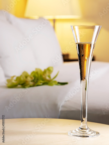 Romantic evening in an interior with a glass of a champagne photo