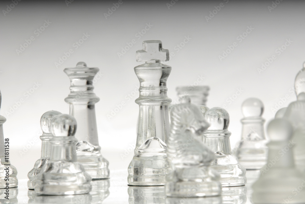 Chess king standing with other pieces Chess king standing with other pieces