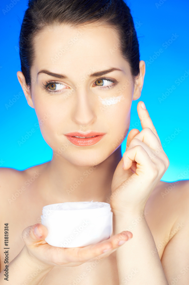 Portrait of beautiful woman holding cream Portrait of beautiful woman holding cream