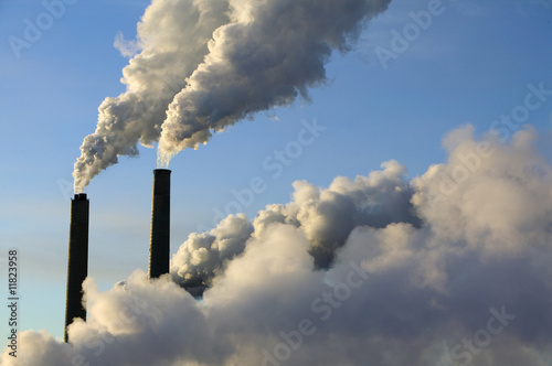 steam rise from smokestacks at an electrical generating plant