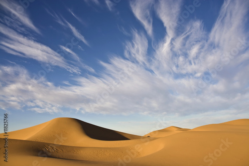 desert dunes with cloudy blue sky