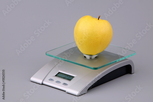 Yellow apple on scales