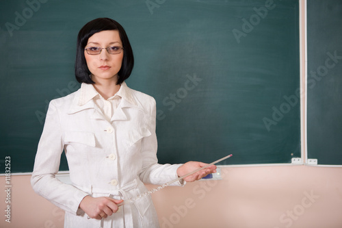 Fotografija young teacher woman on green board