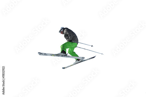 skier in bright green trousers jumping in the air