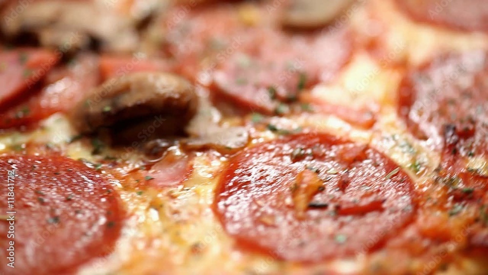 Close up of a spinning pepperoni pizza - loop